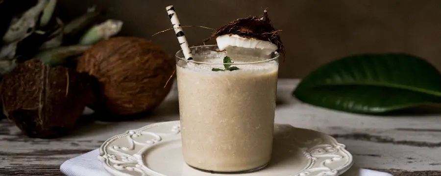 Download a special and artistic image of a coconut smoothie with a beautiful decoration