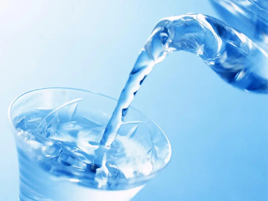 Fantasy and light blue photo of pouring drinking water into a glass