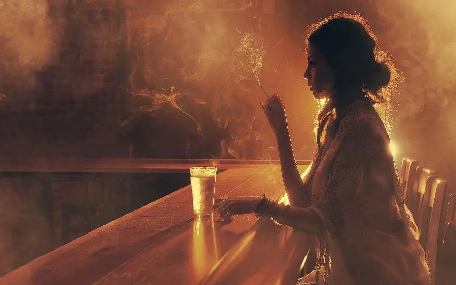 Special and warm image of a smoking girl drinking