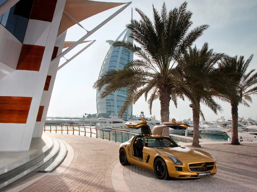 Beautiful vector of yellow Mercedes-Benz next to palm trees and in front of the hotel