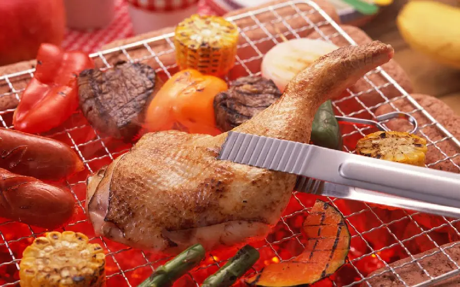 Download a premium quality stock photo of a perfectly grilled chicken thigh kebab, with meat and cobs, red bell peppers, asparagus on a grill