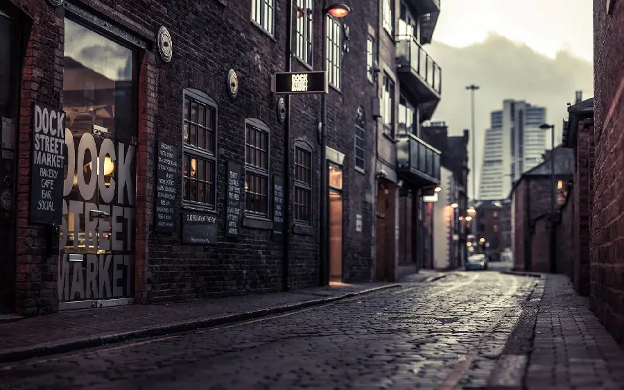 Unique photo of a small and dark part of a city road without passers-by