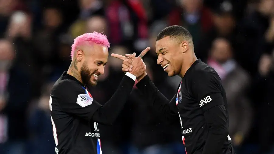 Photo of Neymar with pink hair and Mbappe in a black dress, shaking hands in their own way