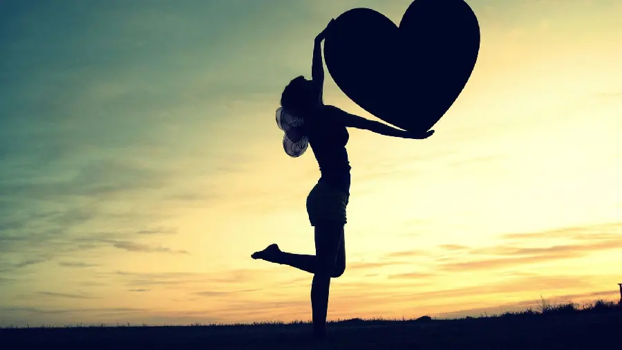 The most beautiful girlish background of a heart with a sunset sky background for Windows 11
