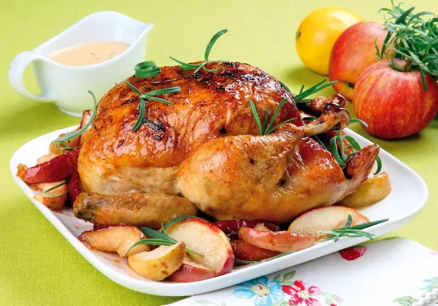 Download full HD quality background of a beautiful complete chicken kebab with red and yellow apple garnish and special sauce and decorated with tarragon