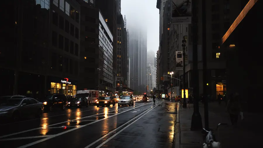 A scary stock photo of a night scene with cars on a city road
