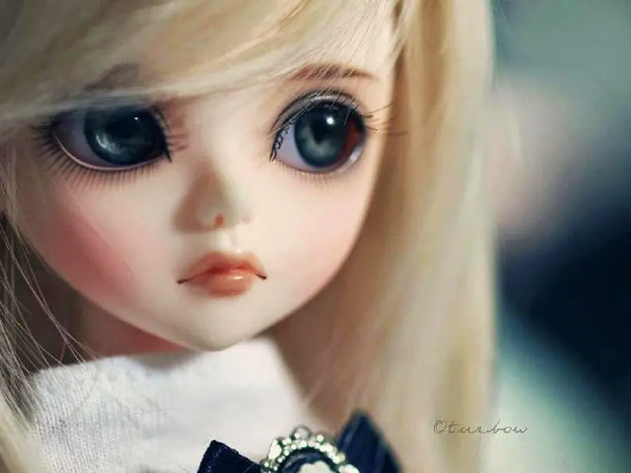 Artistic close-up of a little girl doll with an innocent face