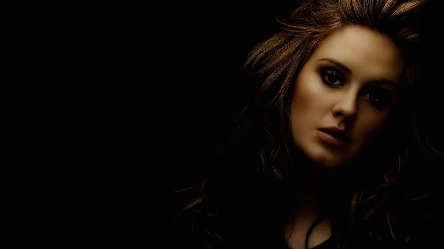 Download photo of a serious and proud background of the famous British singer Adele in the dark