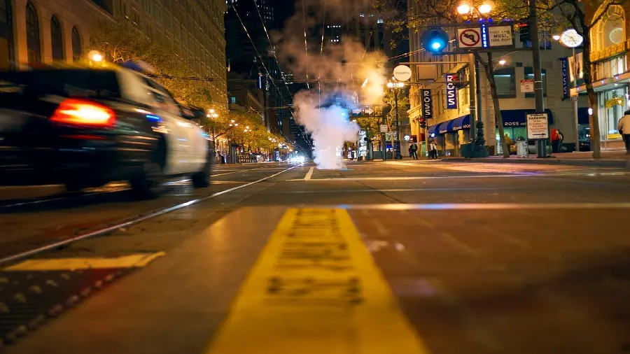 Download strange and bright stock photo of a city street and smoke from chaos and police cars