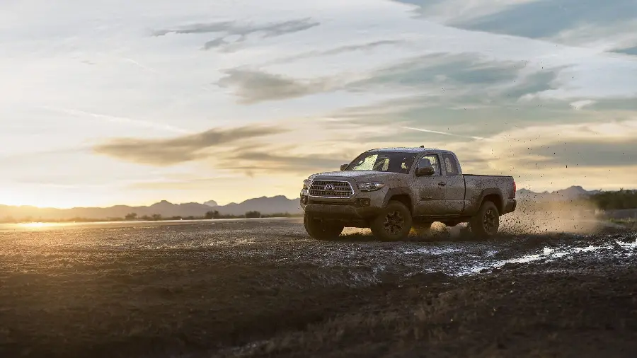 New background image of Toyota Tacoma off-road in the mud