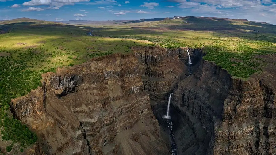Unique background of green nature around Siberian waterfalls