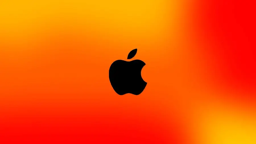 Apple laptop background with a black bitten apple in high quality with an orange, red and bright yellow background