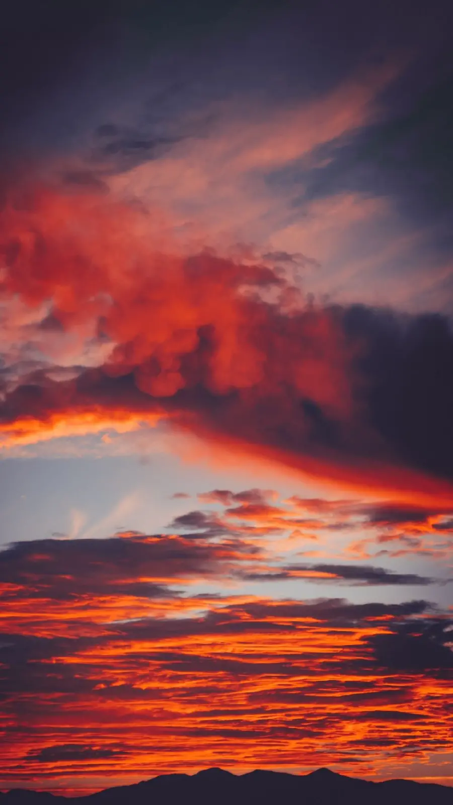 Download the strange sunset image of the sky with colorful orange and black clouds in hd quality