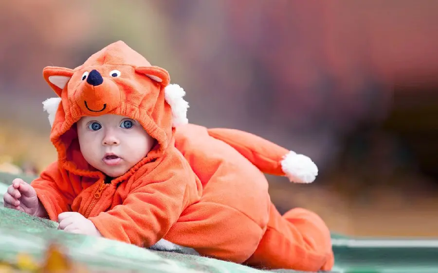 Photo of a naughty and cute little girl with an orange fox fantasy dress in HD quality 