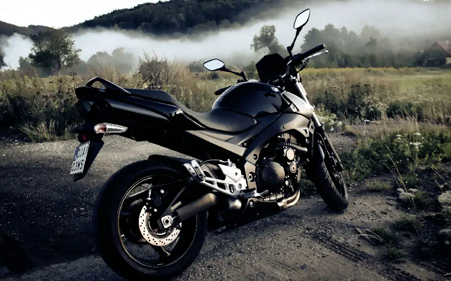 Download exciting photo of black motorcycle in green plain with FUII HD quality