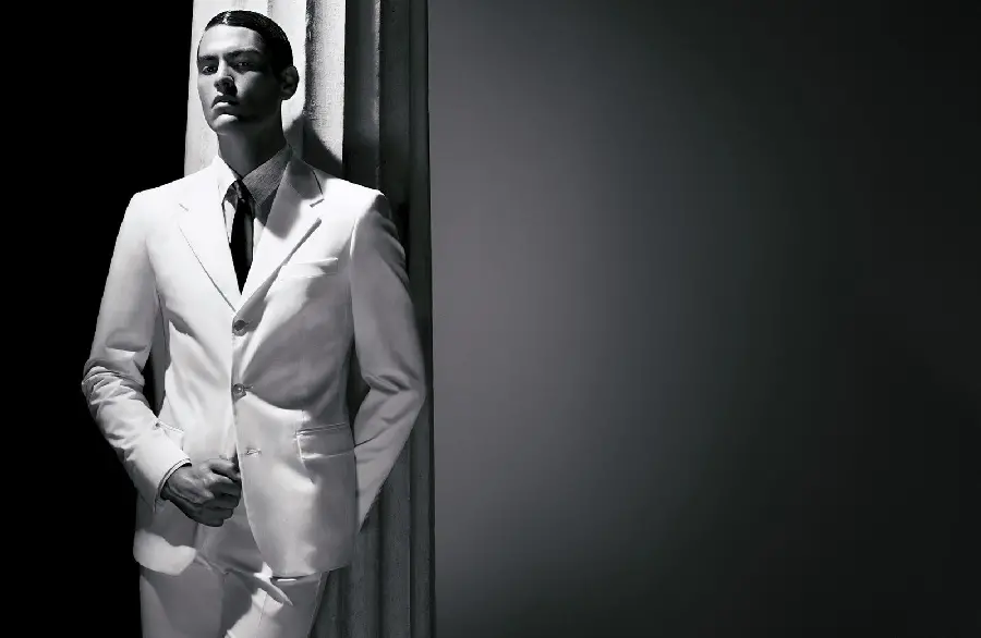 Beautiful and impressive image of an attractive male model in a white suit 