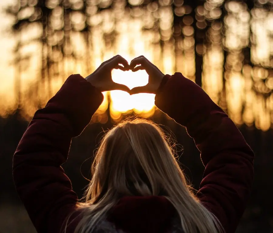 Magical girl profile heart with hand in sunset light in HD quality