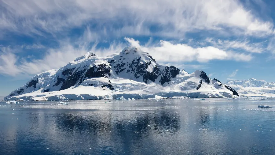 New stock image of frozen ocean and snowy mountains in front of it in HD quality