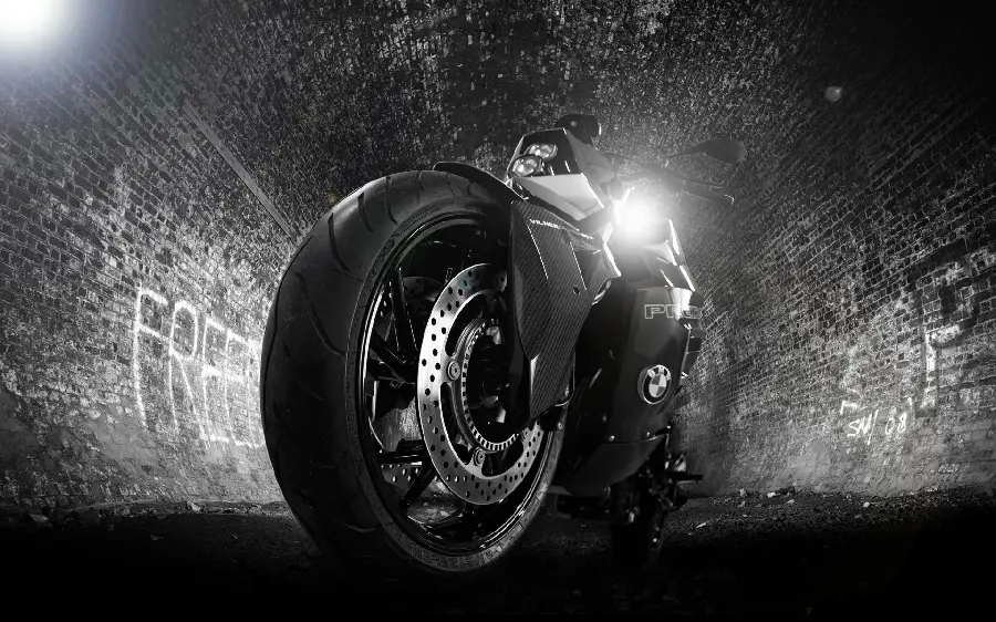 Artistic stock photo of black motorcycle tires in a tunnel