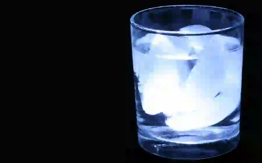 Sad and black background photo of a glass of drinking water with ice