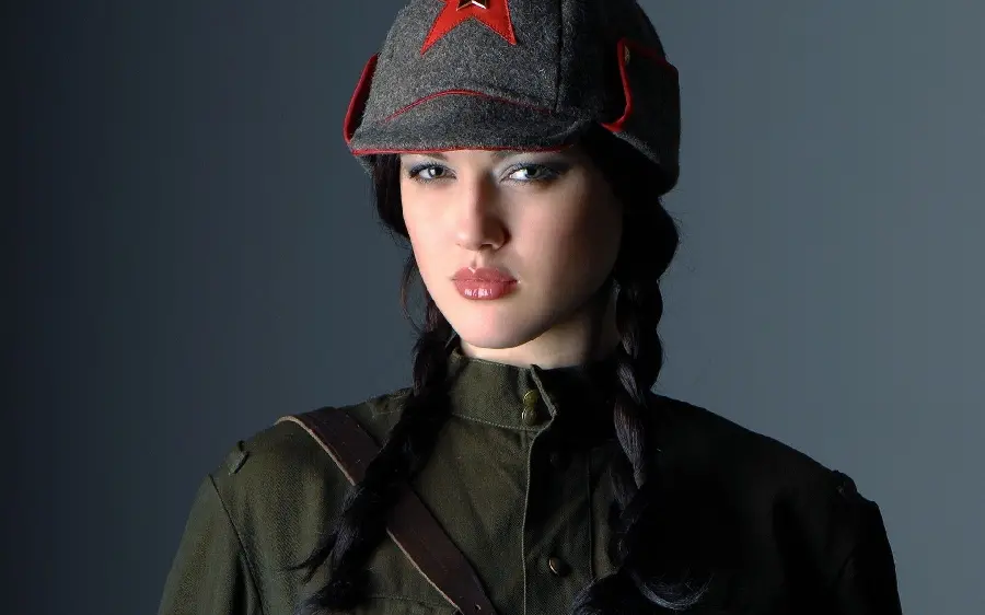 Download popular stock photo of a girl in a green military uniform and a black hat with red stars and black hair