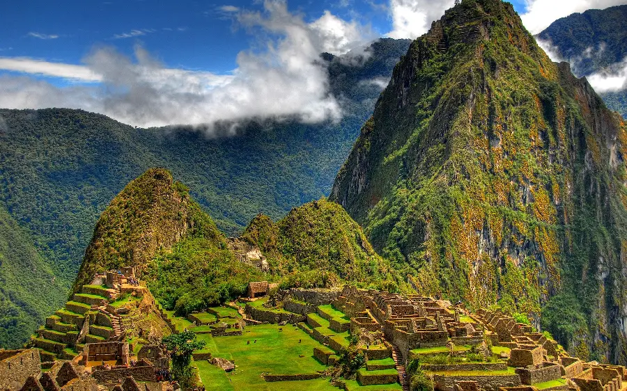 Background photo of lush mountains and temple buildings built on them in the city of Machu Picchu