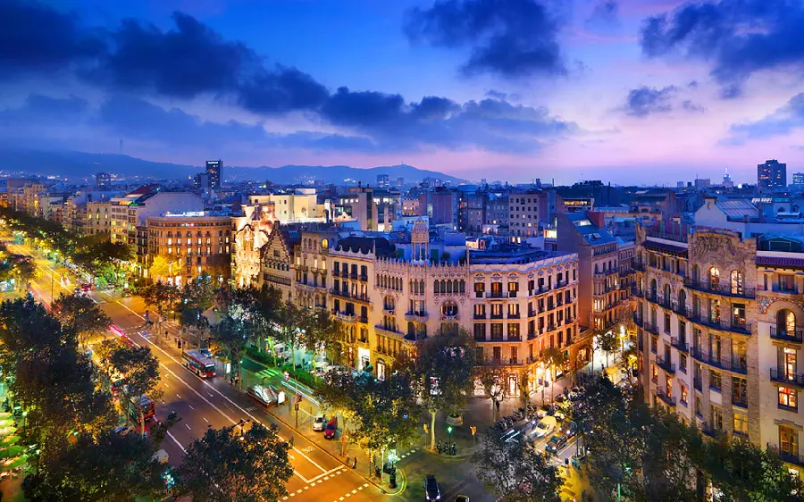 A stunning and special laptop background photo of the long and green streets of Barcelona with proper lighting