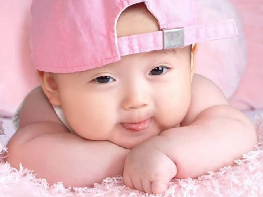 Download a pink wallpaper of a cute baby boy in 8K quality