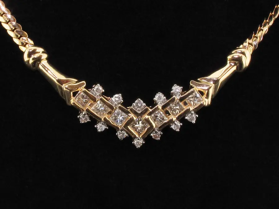 Unique HD image of a gold jeweled necklace with a black background suitable for Instagram 