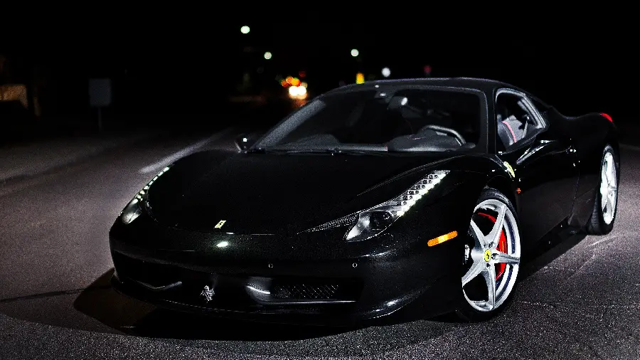 Stylish and eye-catching profile photo of a black Ferrari car from the front 2022