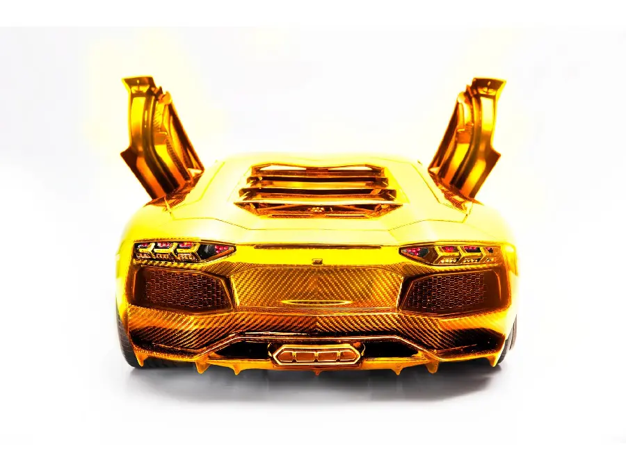 Glamorous wallpaper of a completely golden Lamborghini with a simple white background 