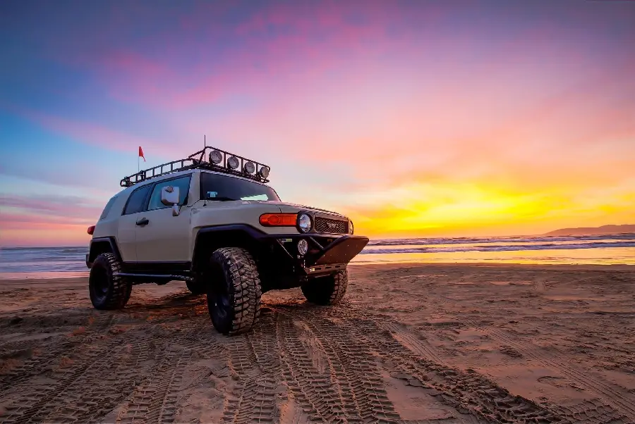 Download photo of the Toyota car on the beach at sunset