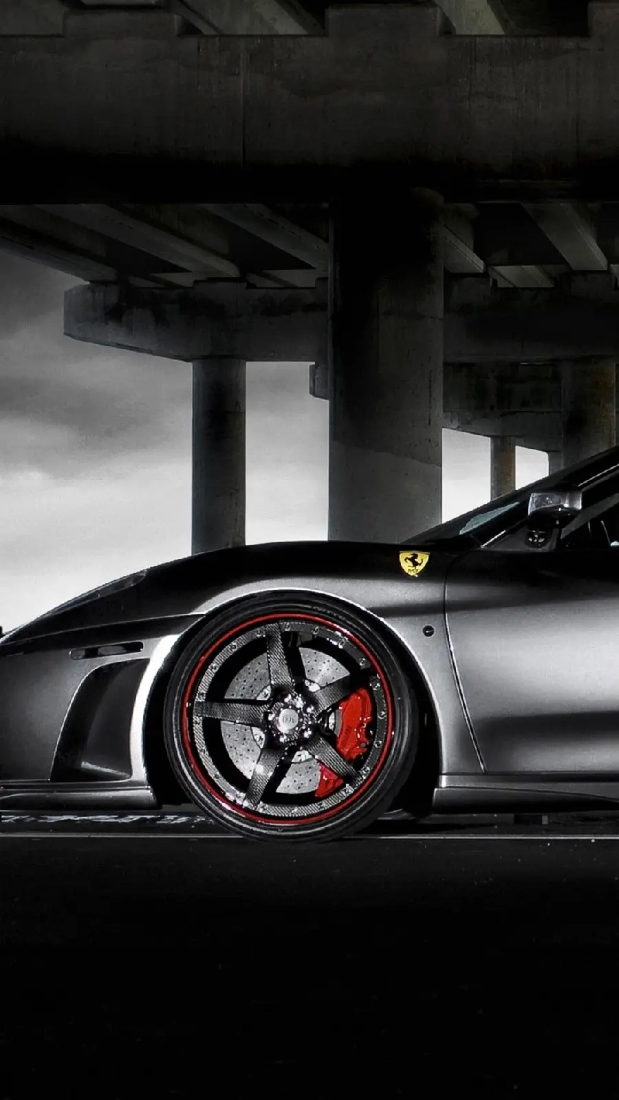 Photo of a black Ferrari with special rims from the side