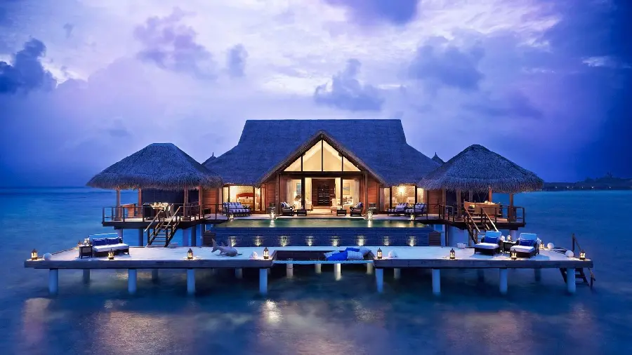 A modern and high quality background of a beach house villa with sun loungers on the water and blue sky