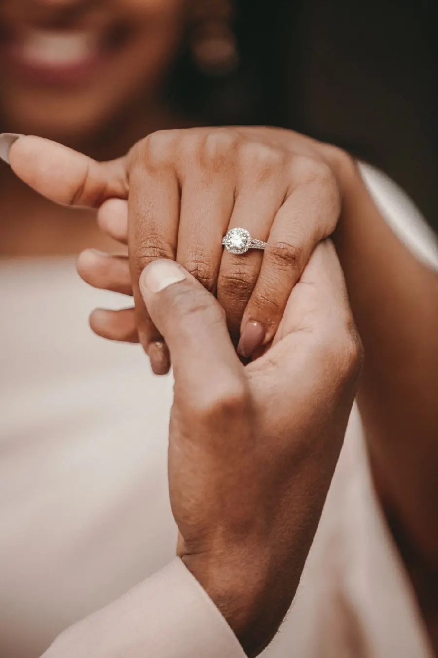 Bad poster of a groom showing off the bride's ring with ugly hands