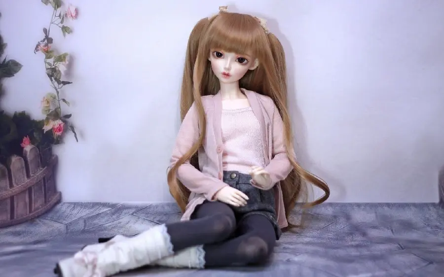 Lovely picture of a sitting girl doll in HD quality