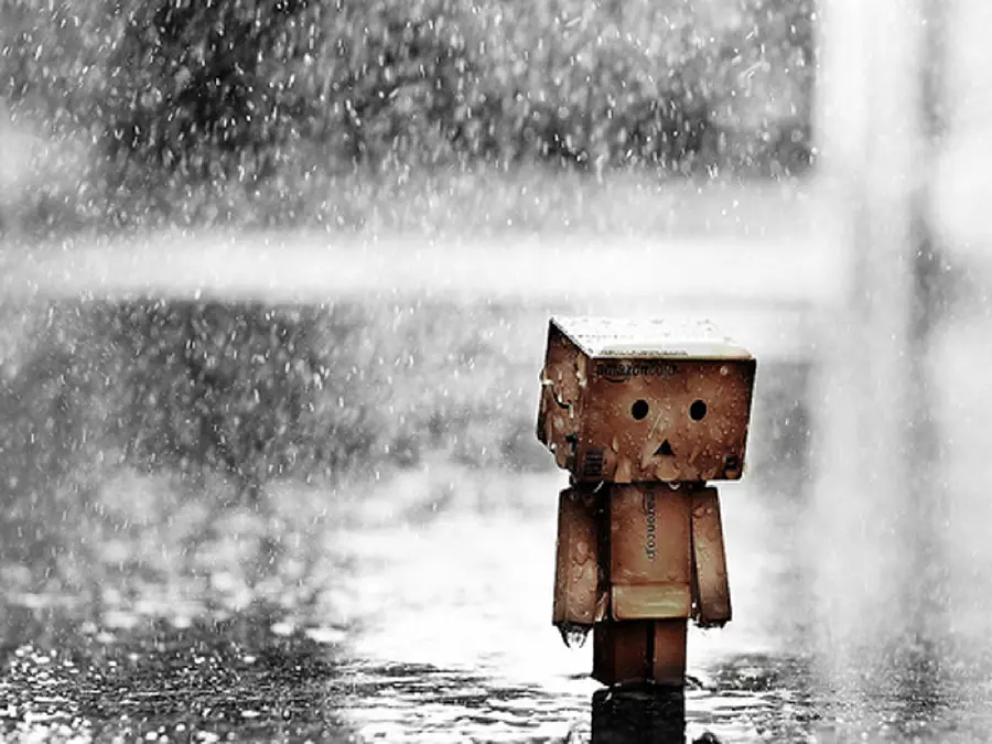 Download stock photo of a sad rain-stricken man