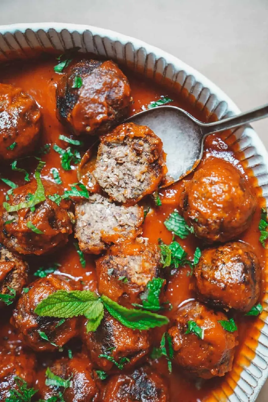 The latest HD quality image of a delicious and delicious Kofte dish dipped in tomato sauce on a copper serving tray suitable for phones