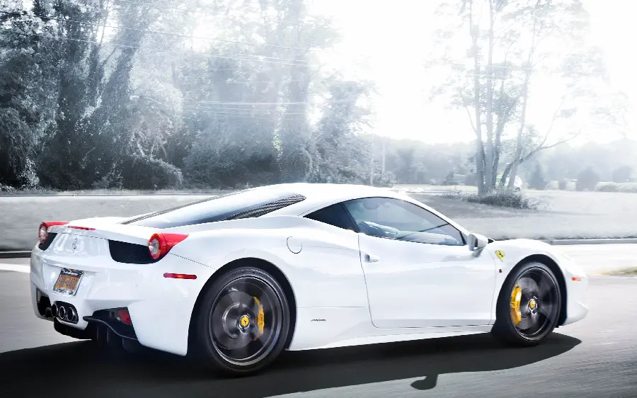 A brilliant stock photo of a cute white Ferrari taken in the forest