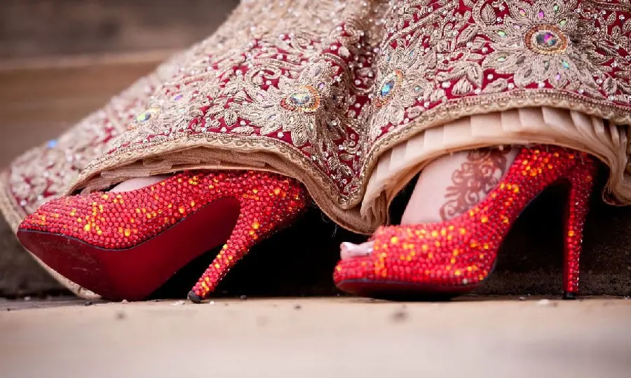 Impressive image of red high heels with wreath with traditional long shirt 