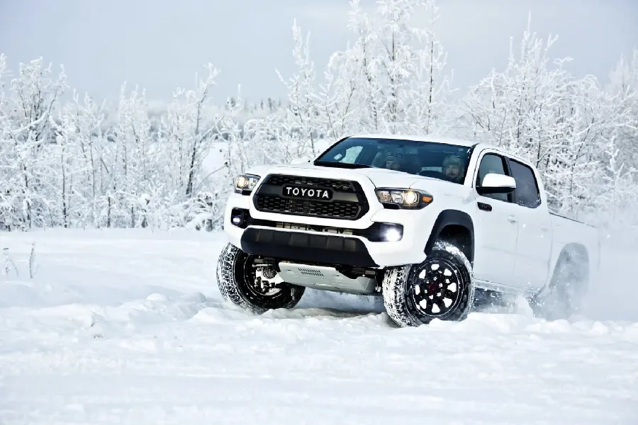 The most amazing background photo of a white Toyota Tacoma in heavy snow
