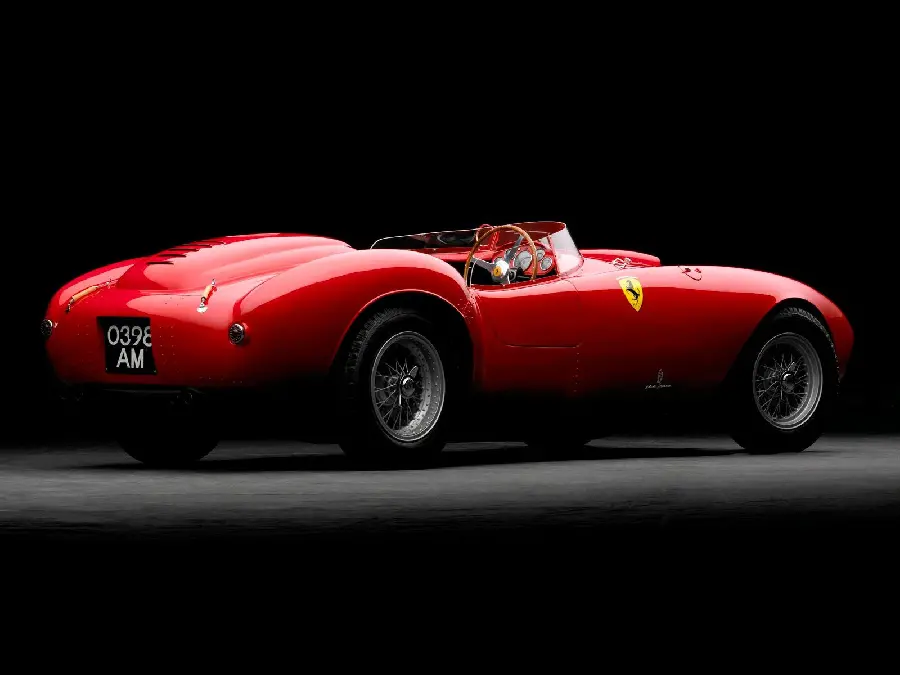 Dark and black background of an old and classic red Ferrari without a roof in high quality