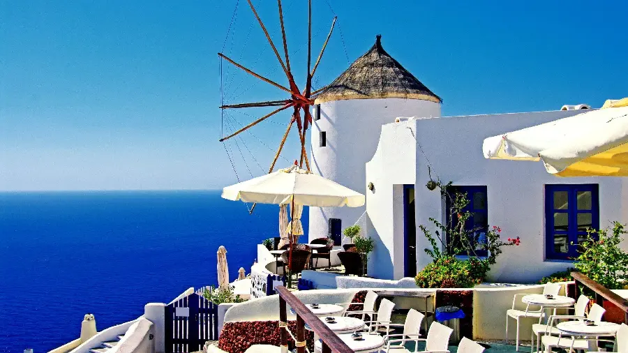 Cute wallpaper of a famous windmill in a village in Santorini, special for your phone