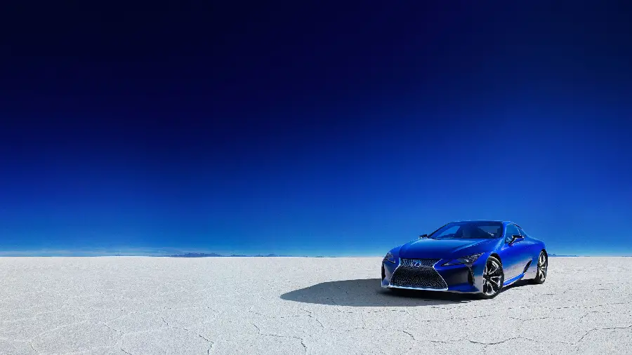 Blue Lexus LC 500 profile photo on white ground with bright blue sky