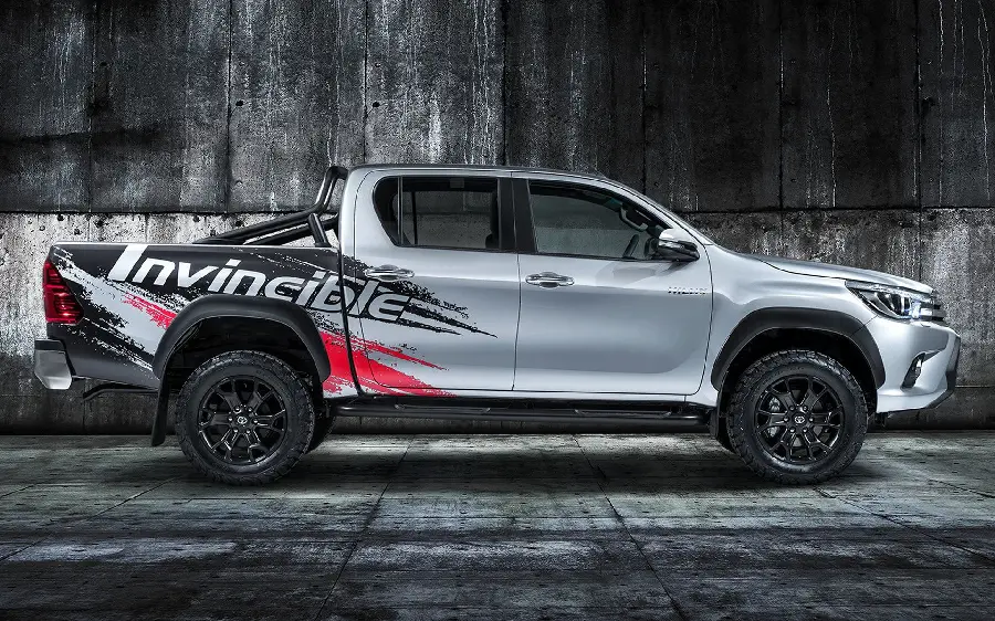 Fantasy image with a dark and rough background of Toyota Hilux from the side with black and red lines on it