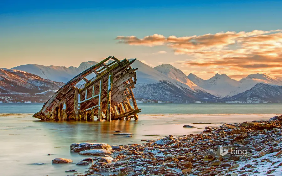 Unfortunate wallpapers and backgrounds of a broken wooden barge in the sea and near the rocky shore of nature