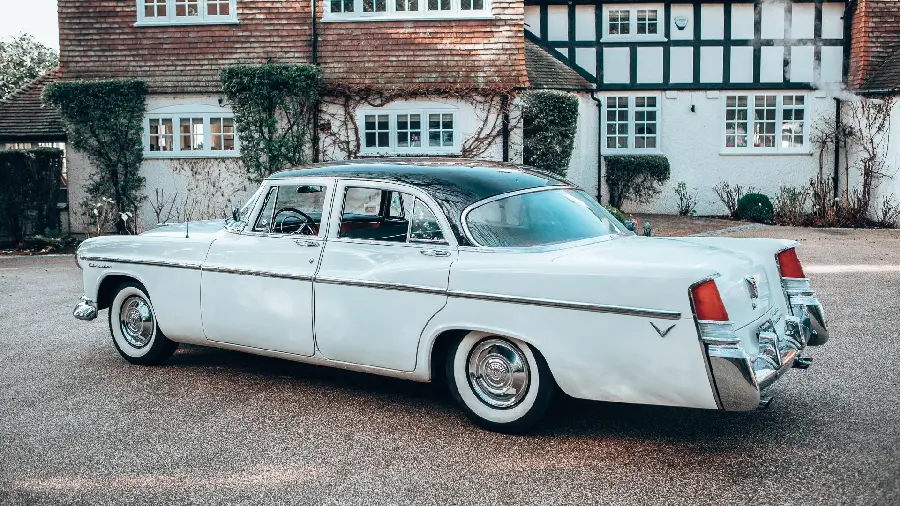 Attractive wallpaper of a classic white car with a background of houses next to it in high quality for special people of Windows