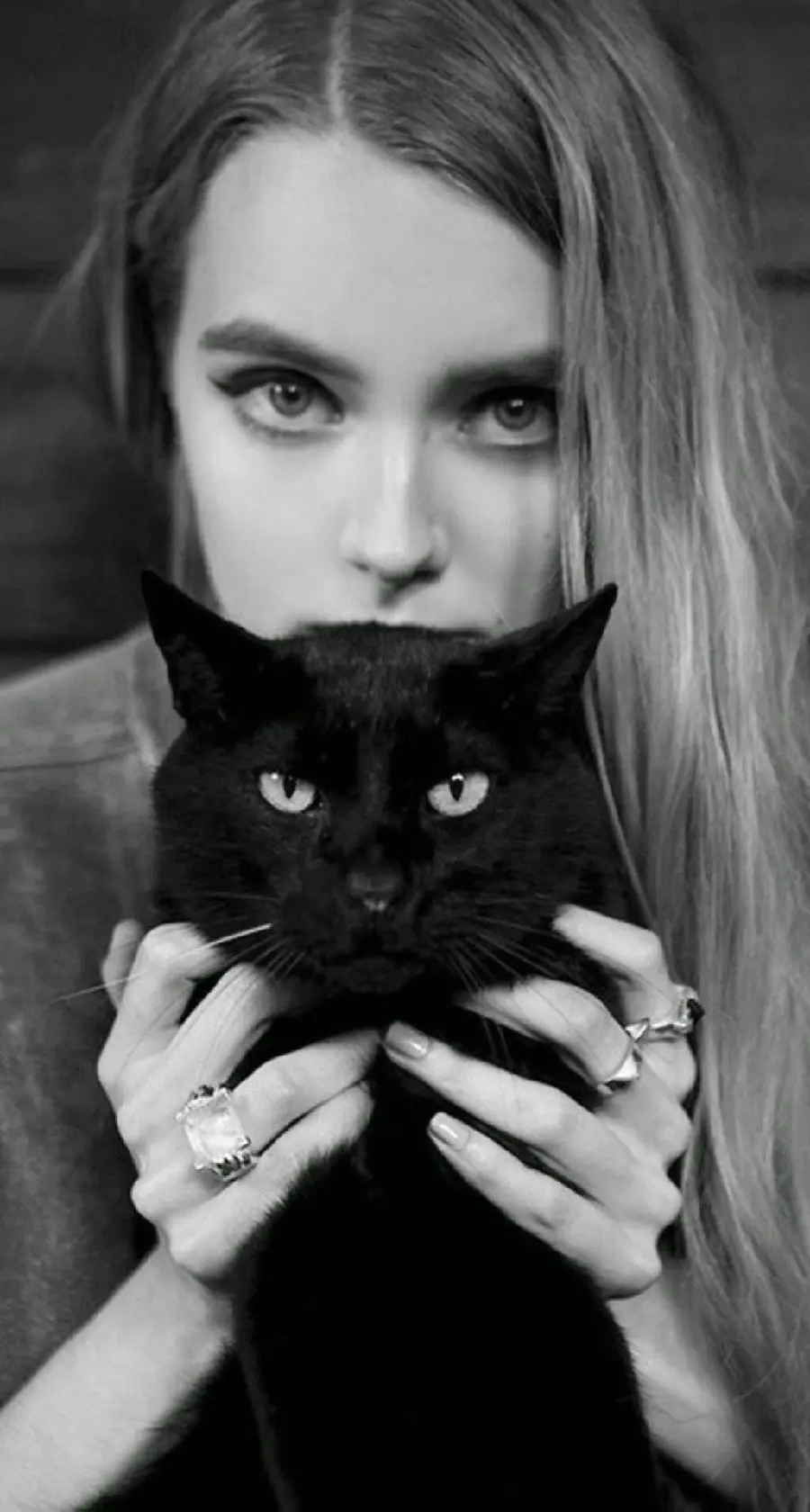 Girly wallpaper of a beautiful girl with a black cat in her hands