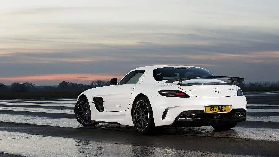 Download the trendy background image of a white Mercedes-Benz on a rainy road with dark clouds