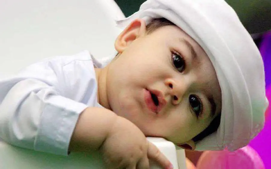 Masterpiece stock photo of a beautiful little baby in a white dress 